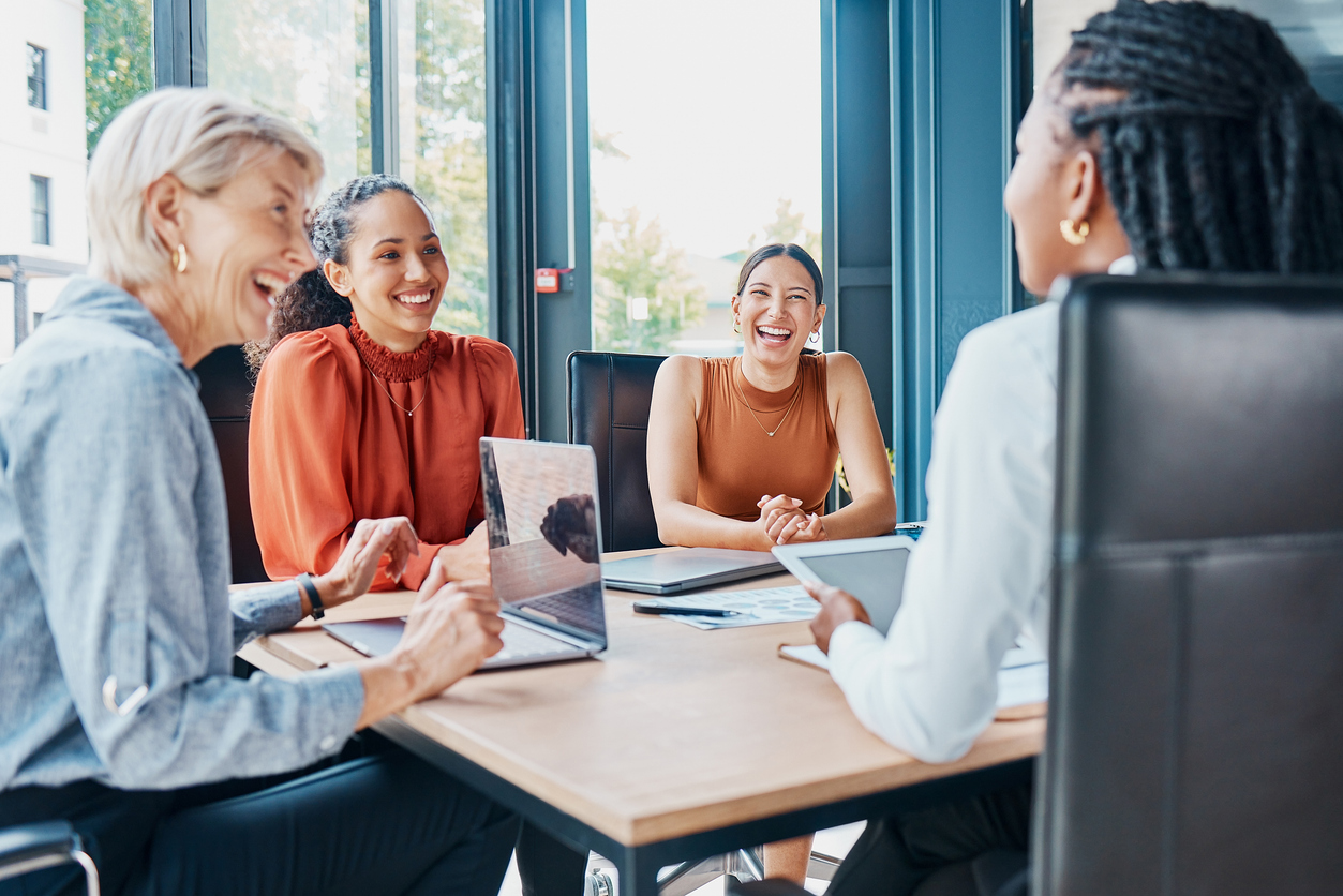Cropped shot of a diverse group of businesswoman sitting around the boardroom table during a meeting